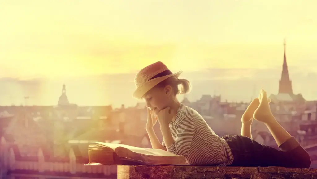 A Little Girl Reading A Book On The Roof 